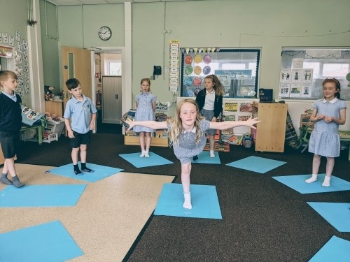 Children doing yoga poses.