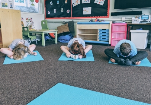 Children doing yoga poses.